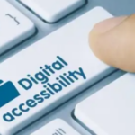 A person's index finger rests on a key with a digital accessibility icon on it.