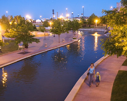 A woman and her daughter taking a walk by the riverside in downtown Pueblo.