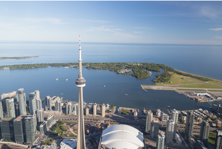 Ontario skyline shows the city facing the blue expanse of the sea on a clear day.