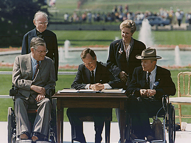 Pres. George H.W. Bush signing the Americans with Disabilities Act, on the South Lawn of the White House, July 26, 1990.