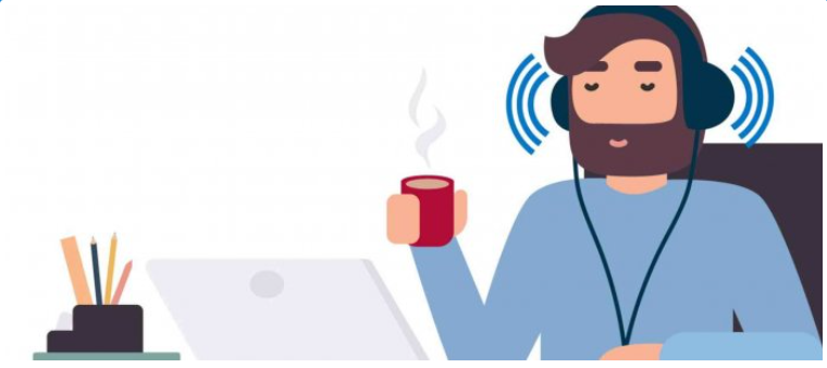 Screen reader accessibility tester is listening to an audio from a laptop. He is holding a cup of hot beverage in his right hand.